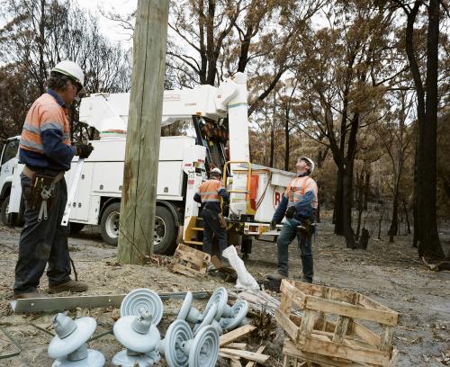 Workmen repairing power lines in bushfire ravaged landscape - Australian Stock Image