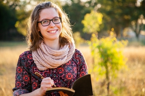 Writer holding fountain pen and notebook for writing in - Australian Stock Image