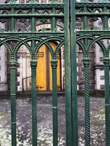 Wrought iron gates with church door in background