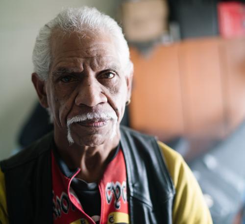 Wurundjeri Elder with white mustache wearing leather vest - Australian Stock Image