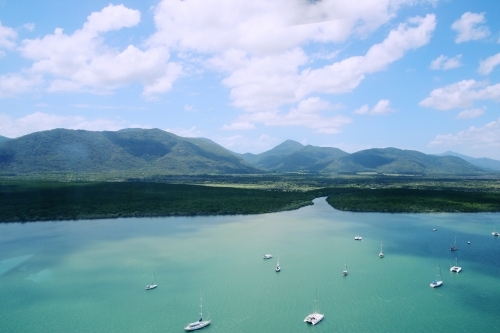 Yachts moored on green harbour from above - Australian Stock Image