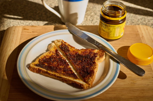 Yeast extract on toast with jar and cup - Australian Stock Image