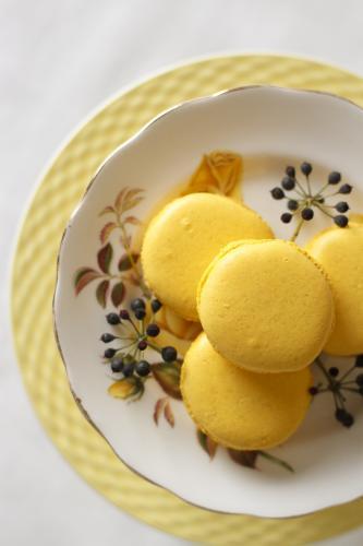 Yellow macarons on cake stand - Australian Stock Image