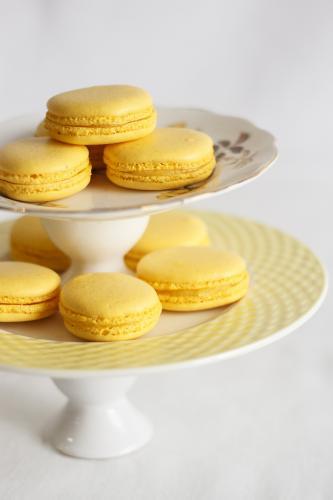 Yellow macarons on cake stand - Australian Stock Image