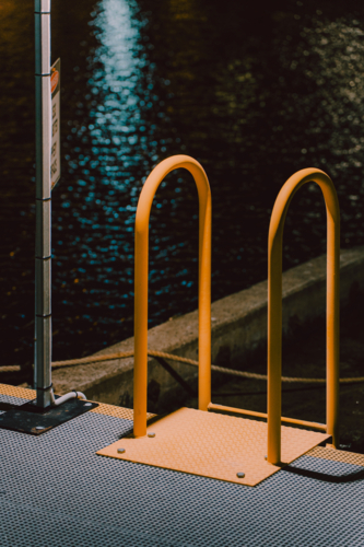 Yellow metal handrail at the dockside - Australian Stock Image