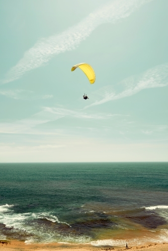 Yellow parachute on the coast with a horizon