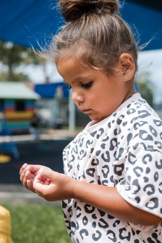 Young Aboriginal girl outside at preschool