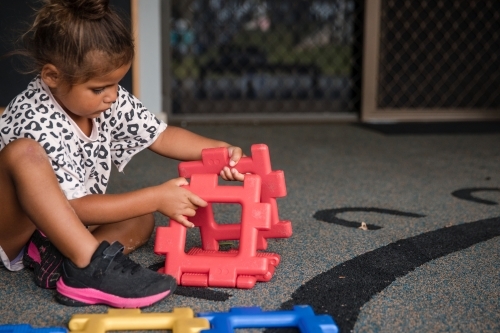 Young Aboriginal girl playing at preschool - Australian Stock Image