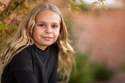 young aboriginal girl with brown eyes and long blonde hair