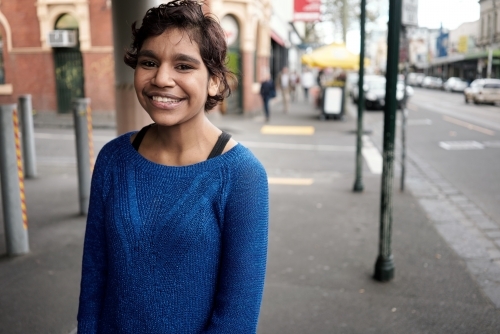 Young Aboriginal Woman in town street - Australian Stock Image