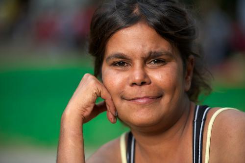 Young Aboriginal Woman resting her head on her right hand - Australian Stock Image