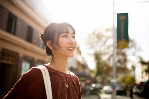 Young adult asian woman exploring the inner west urban streets of Sydney - Australian Stock Image