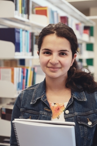 Young adult student in university library - Australian Stock Image