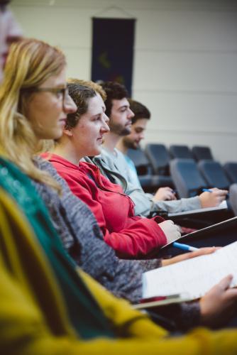 Young adult students listening to professor a university lecture hall - Australian Stock Image