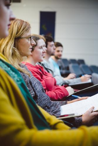 Young adult students sitting in a university lecture hall