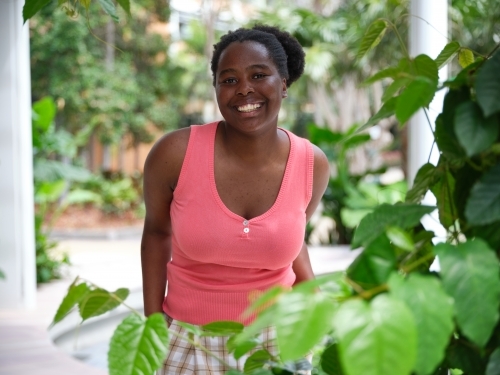 Young African woman in university courtyard - Australian Stock Image