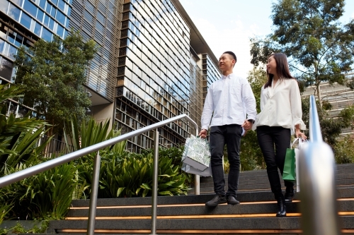 Young Asian couple shopping together in city - Australian Stock Image