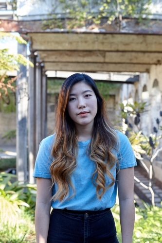 Young Asian woman enjoying time outdoors at enclave - Australian Stock Image