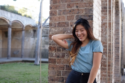 Young Asian woman enjoying time outdoors at enclave - Australian Stock Image