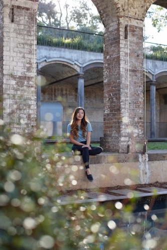 Young Asian woman enjoying time outdoors at enclave - Australian Stock Image
