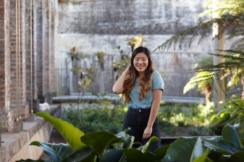 Young Asian woman enjoying time outdoors at enclave - Australian Stock Image