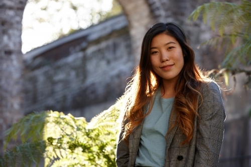 Young Asian woman enjoying time outdoors at enclave - Australian Stock Image