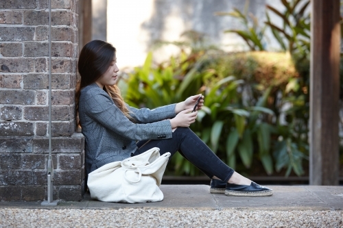 Young Asian woman enjoying time outdoors at enclave - Australian Stock Image