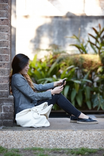 Young Asian woman enjoying time outdoors at enclave - Australian Stock Image