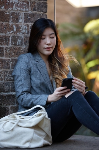 Young Asian woman enjoying time outdoors at enclave