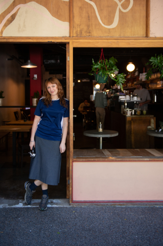 young barista outside an inner city cafe - Australian Stock Image