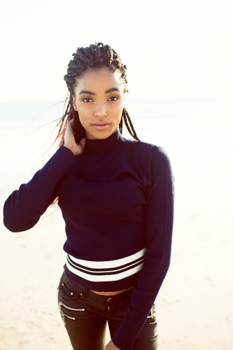 Young black woman posing on the beach - Australian Stock Image