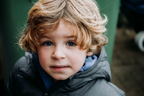 Young boy in warm jacket on overcast winter day - Australian Stock Image