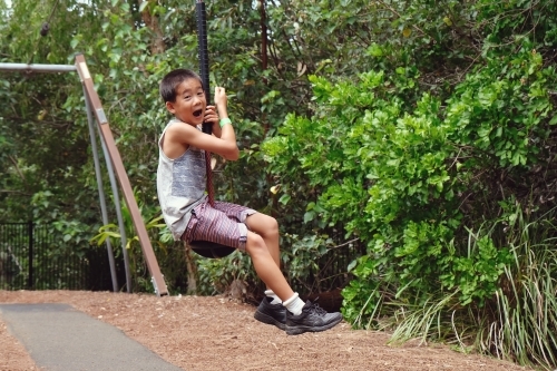 Young boy on flying fox at playground - Australian Stock Image