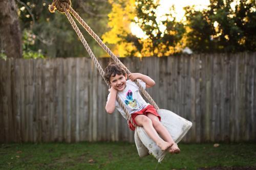 Young boy on rope swing