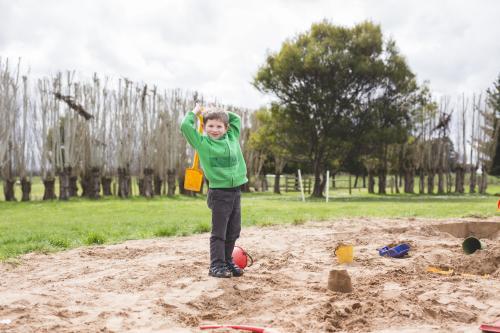Young boy playing in sandpit