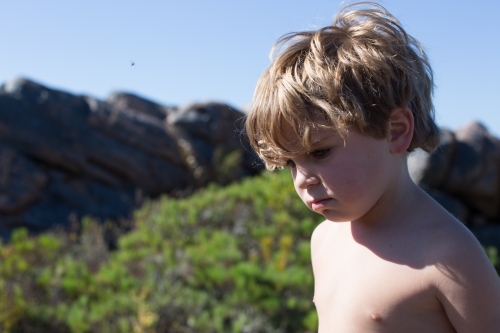 Young boy with no shirt at the beach - Australian Stock Image