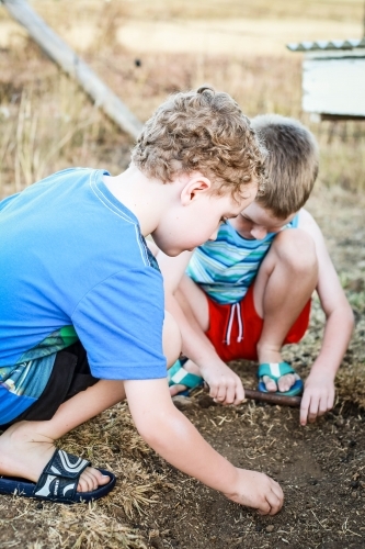 Young boys playing in dirt in drought