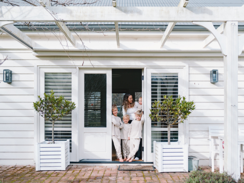 Young boys with mum standing in the doorway - Australian Stock Image