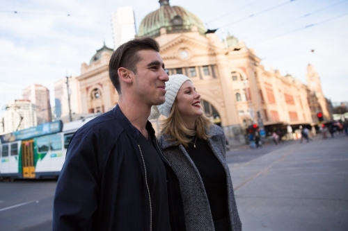 Young Couple Crossing Flinders Street in Winter - Australian Stock Image