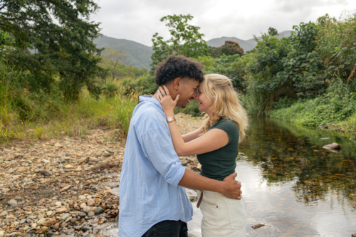 Young couple embracing at a creek in far north Queensland - Australian Stock Image