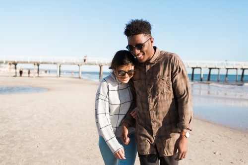 Young couple walking together on the beach - Australian Stock Image