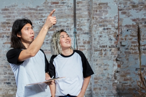 Young event planners working together on set - Australian Stock Image