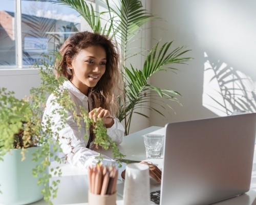 Young executive working in an office with indoor plants