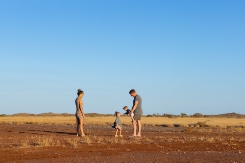 young family of four in the Pilbara landscape with big blue sky