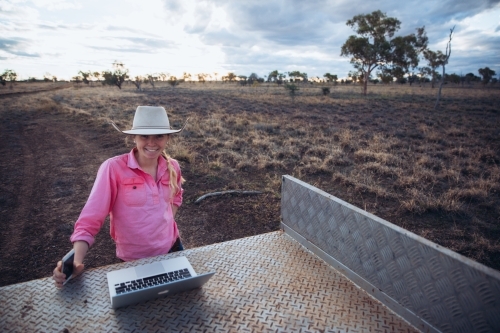 Young female farmer with communication devices