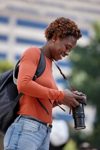 Young female photographer in city - Australian Stock Image