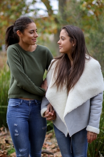 Young female same sex couple walking hand in hand - Australian Stock Image