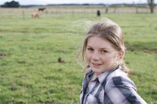 Young girl at horse riding farm