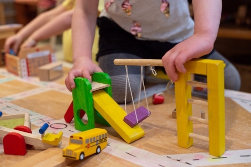 Young girl child playing with building toys - Australian Stock Image