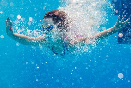 Young girl diving underwater - Australian Stock Image